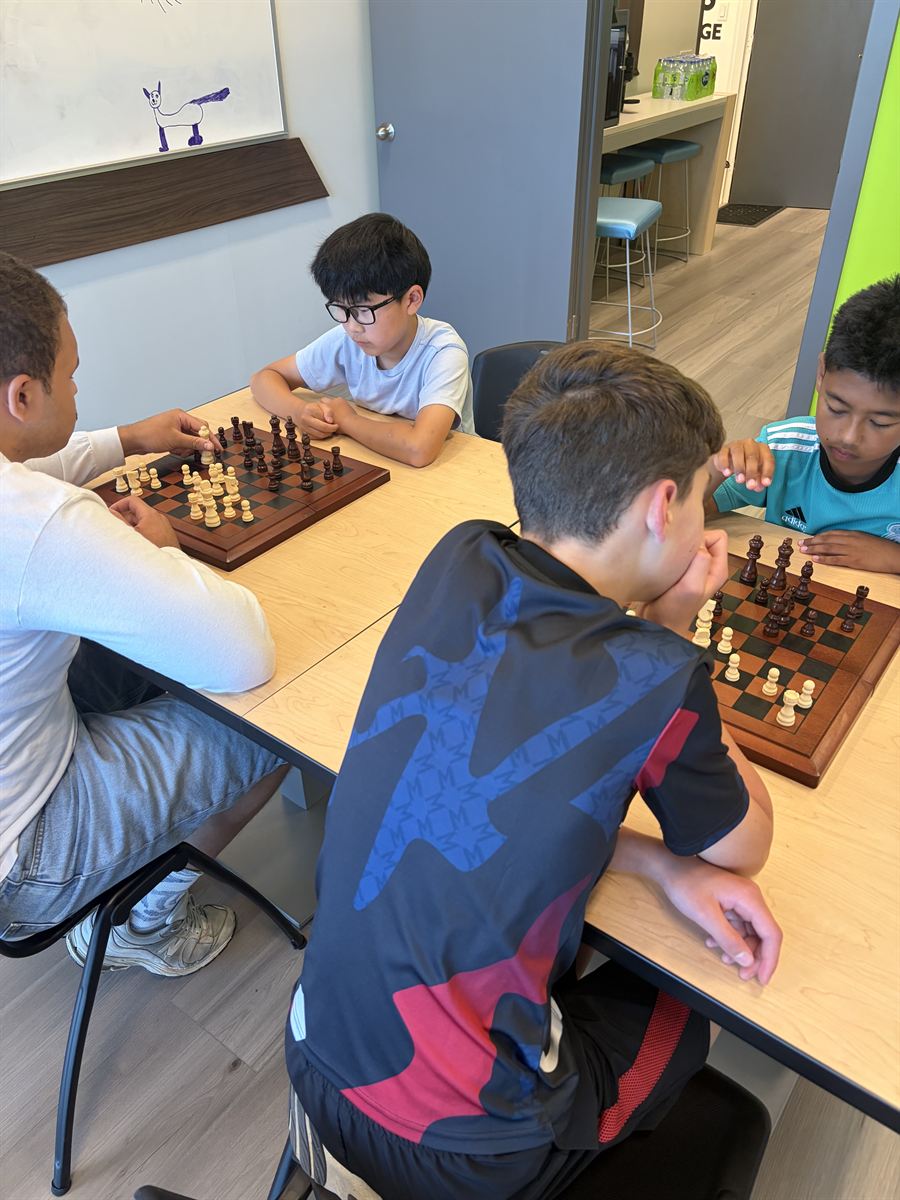 Four ninjas mid-game across two chess boards at the center.